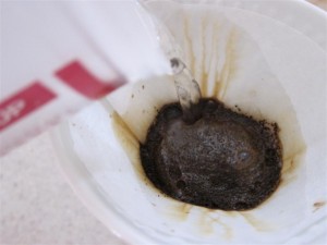 Pour hot water over the coffee grounds Pour hot water over the coffee grounds